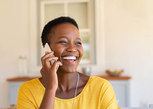 black-woman-near-retirement-calling-on-phone-smiling